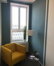 Leseecke am Fenster mit gelbem Sessel, Stehlampe und Beistelltisch