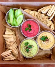 Hummus Trio Catering Tray: homemade garbanzo, beet, and edamame hummus plus pita bread and cucumber slices