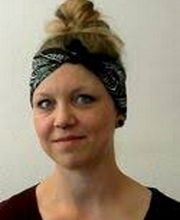 Portrait einer WBS Bildungsreferentin, die blonde Haare hat und ein Stirnband trägt.