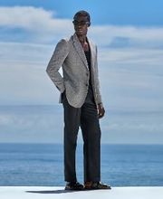 This black blazer is cut to a tailored fit, providing a sharp silhouette with natural shoulders. It features notch lapels, flap pockets, and a refined construction for a classic, polished look.