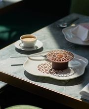 Elegant table setting at Le Jardinier, showcasing fine dining with modern plating and soft natural light.