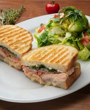 Salmon Brie Panini (Grilled Sustainable Fresh Atlantic Salmon, Melted Brie, Roma Tomatoes, Fresh Dill, Capers & Red Onions)