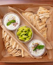Tzatziki Catering Tray: Tzatziki spread along with pita bread and cucumber slices