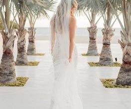 Bride walking towards the beach