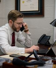 Calum Welch Yorktown VA criminal defense attorney talking with a client on the phone