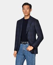 This navy checked blazer is cut to a tailored fit with a slim chest and waist for a fitted silhouette and natural shoulders. It features wide notch lapels, jetted pockets, and a half-canvas construction.