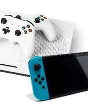 A white Xbox One console with two matching controllers, paired with a red and blue Nintendo Switch console, showcasing popular gaming devices.