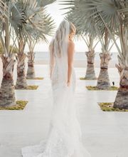 Bride walking towards the beach