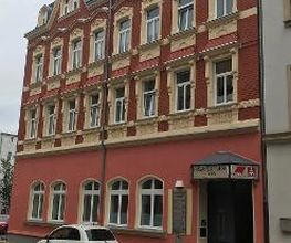Mehrstöckiges Schulungsgebäude mit roter Backsteinwand.