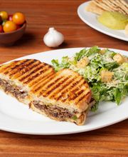 Steak Panini (Flat Iron Steak w/ Grilled Mushrooms, Bell Peppers, Onions, Melted Smoked Mozzarella Cheese, and Persian Pickles