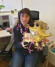 Eine Frau hält eine Geburtstagsaufmerksamkeit in der Hand.