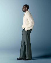 This off-white polo sweater features an open V-neck with a spread collar and no button placket, knitted in a soft, fluffy bouclé texture with long sleeves and a relaxed silhouette.