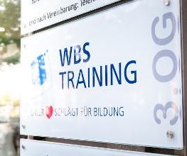 Namensschild WBS Training im äußeren Eingangsbereich des Schulungsgebäudes.
