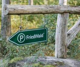 Schilder weisen den Weg zum kostenlosen Parkplatz am FriedWald.