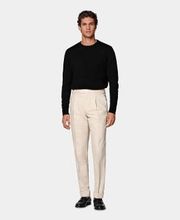 Slim Leg Tapered pants in sand color feature a mid-rise and single pleat. With a straight hip and thigh, tapered leg, side adjusters, jetted-button back pockets, and turn-ups, they offer a modern, tailored look.