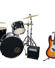 Assorted musical instruments including a guitar, amp, and a drum set with cymbals.