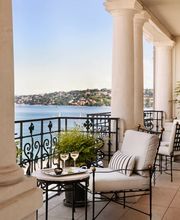 Private terrace with seating area and panoramic lake and city views from The Woodward Geneva suite.