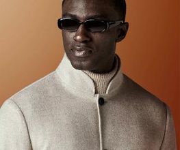 This light brown shirt-jacket is cut to a relaxed fit — easy through the chest and shoulders with a clean, unstructured silhouette — and features a stand collar, patch pockets, and a four-button fastening.