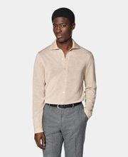 This sand long-sleeve polo cardigan is tailored in a slim fit and features a polo collar, full placket with a 7-button closure, and lightweight fabric for stylish, comfortable wear.