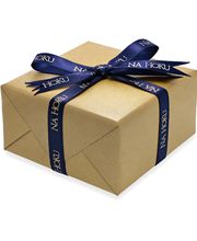golden gift wrapped box and blue ribbon with golden Na Hoku print