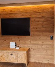 JAPS Holz GmbH - Integrierte Altholzwand mit Fernseher im Wohnzimmer
