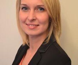 Frau mit blondem Haar schaut freundlich.