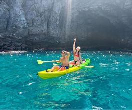 pareja de novios enncima de un kayak amarillo en mar cristalino 