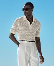 This sand button crochet polo is tailored to a slim fit and features a classic button collar, crochet texture, and ribbed hem and cuffs.