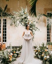 One of our brides posing with floral arrangements