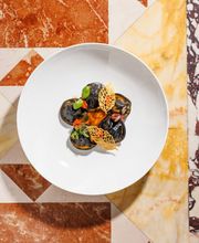 Chef’s Signature: Black ravioli with cuttlefish, caciucco sauce, sun-dried tomato pesto and potatoes