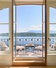 Luxurious suite balcony at The Woodward Geneva overlooking Lake Geneva and the distant Alps.