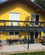 Terrassenüberdachung mit Dachüberstand und Balkongeländer aus Aluminium