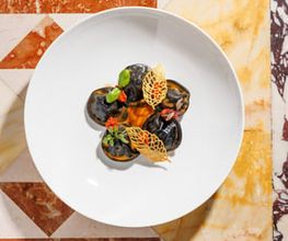 Chef’s Signature: Black ravioli with cuttlefish, caciucco sauce, sun-dried tomato pesto and potatoes