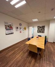 Ein Pausenraum mit einem Tisch und 6 Stühlen.