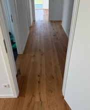 MC Bodenservice aus Braunschweig zeigt die fachgerechte Verlegung eines Parkettbodens im Flur einer Wohnung. Der Boden wurde durchgehend verlegt und sauber an Türöffnungen und Wandanschlüsse angepasst. Das Projekt steht exemplarisch für professionelle Bodenlegerarbeiten im Raum Braunschweig.