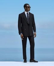 This navy suit is cut to a tailored fit, featuring structured shoulders for a sharp silhouette. Paired with slim trousers, it includes belt loops and a flat front for a clean, modern look.