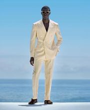 This light yellow suit is cut to a tailored fit, offering a sleek silhouette with structured shoulders. Paired with flat-front trousers featuring side-adjusters for a modern look.