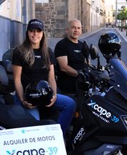 fundadores mujer y hombre encima de las scooter posando para foto