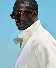 This off-white bomber jacket offers a sleek hip-length cut, high buttoned collar, and raglan shoulders. Features a double-ended zip, flap front pockets, inside pockets, and half-lining for comfort.