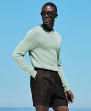 This green crewneck sweater is tailored in a slim fit and features a heavy weight, ribbed hem and cuffs, and a soft texture.