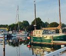 Hafen mit mehreren Schiffen, die angelegt sind.