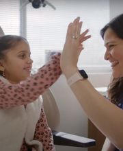 Sakeena Payne, MD, with a pediatric patient